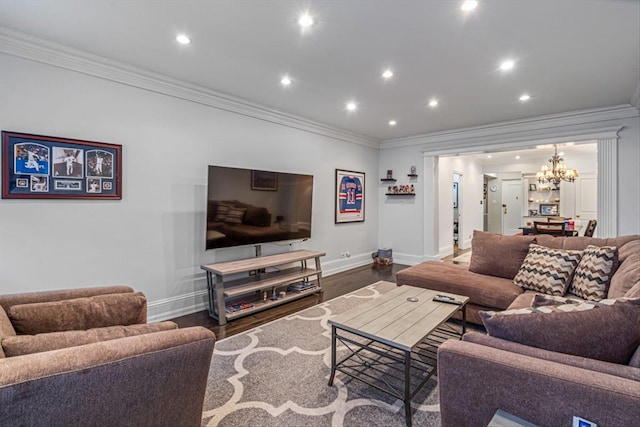 living room featuring crown molding, hardwood / wood-style floors, and a chandelier