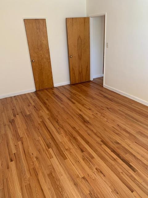 empty room with light hardwood / wood-style floors