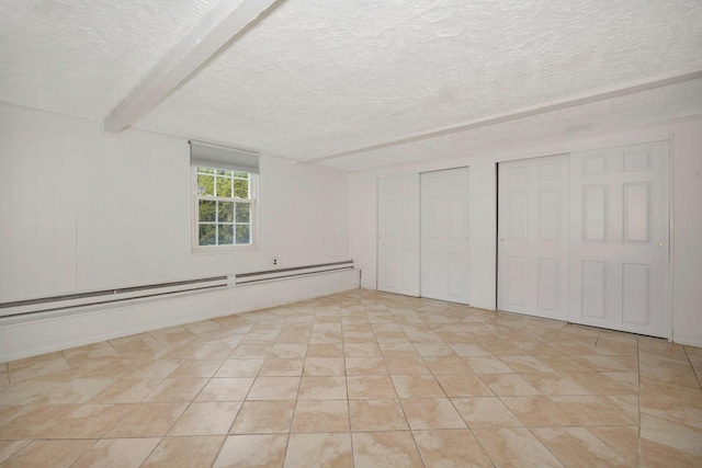 interior space with a textured ceiling, light tile patterned flooring, a baseboard heating unit, beam ceiling, and two closets