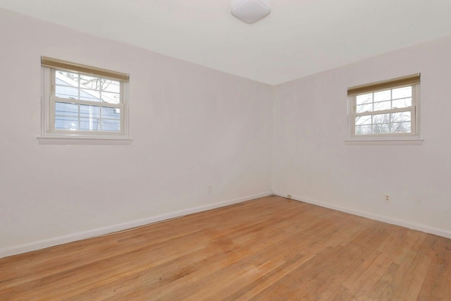 unfurnished room featuring light wood finished floors and baseboards