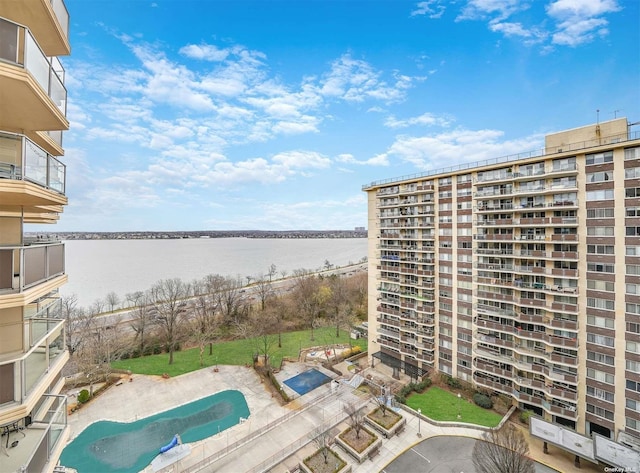 view of pool featuring a patio area and a water view