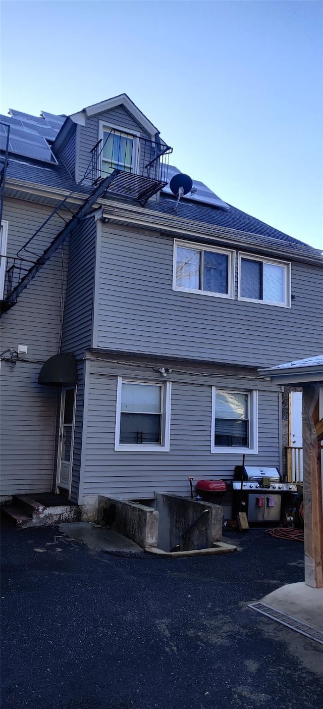 view of property exterior with solar panels