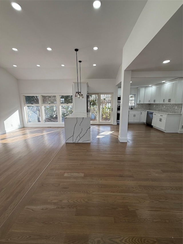 unfurnished living room with dark wood-type flooring and sink