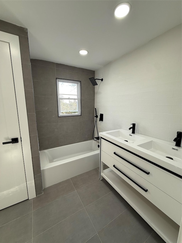 bathroom with tiled shower / bath combo, vanity, and tile patterned floors