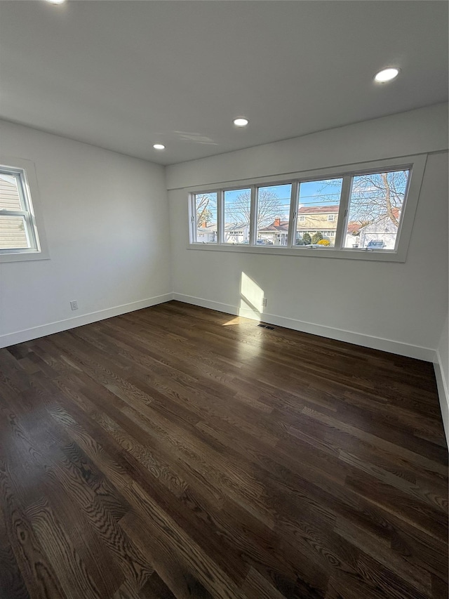 spare room featuring dark wood-type flooring