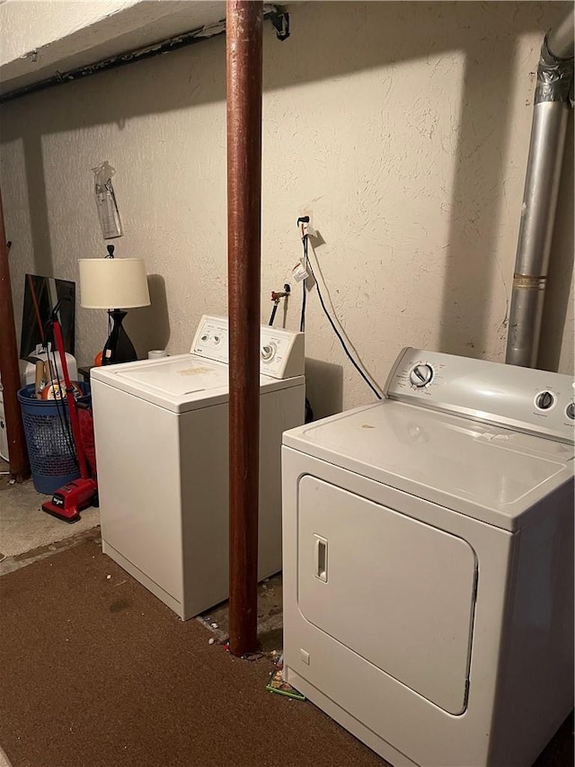 clothes washing area with washing machine and clothes dryer