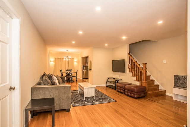 living area featuring stairs, baseboards, wood finished floors, and recessed lighting