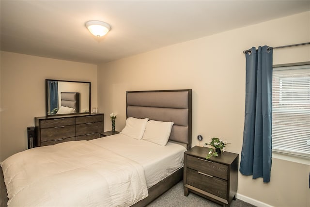 bedroom featuring carpet and baseboards