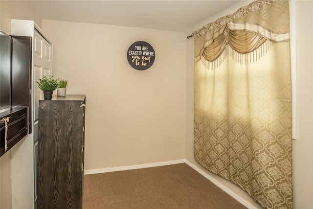 interior space with carpet flooring and baseboards