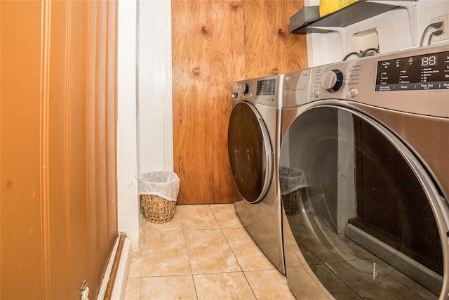 laundry area featuring laundry area, washer and clothes dryer, and tile patterned floors