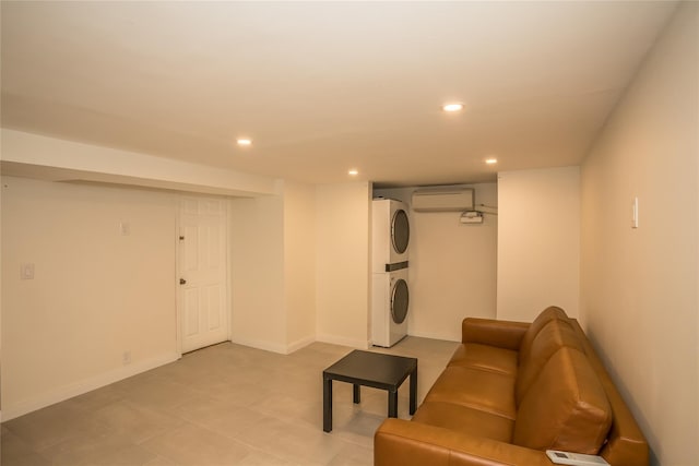 living room with baseboards, stacked washer / dryer, a wall mounted AC, and recessed lighting