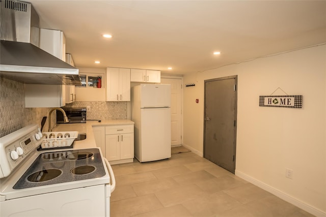 kitchen with recessed lighting, white appliances, white cabinetry, wall chimney range hood, and decorative backsplash