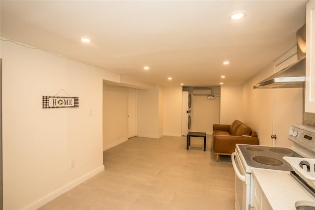 kitchen featuring recessed lighting, white electric range, white cabinetry, open floor plan, and light countertops