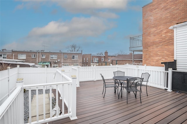 deck featuring a residential view and outdoor dining area