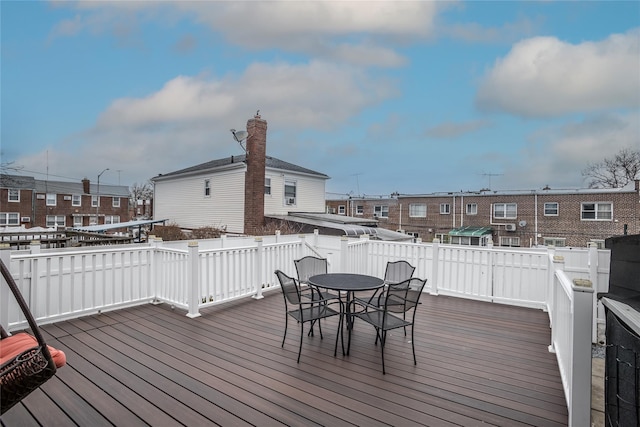 deck with a residential view and outdoor dining space