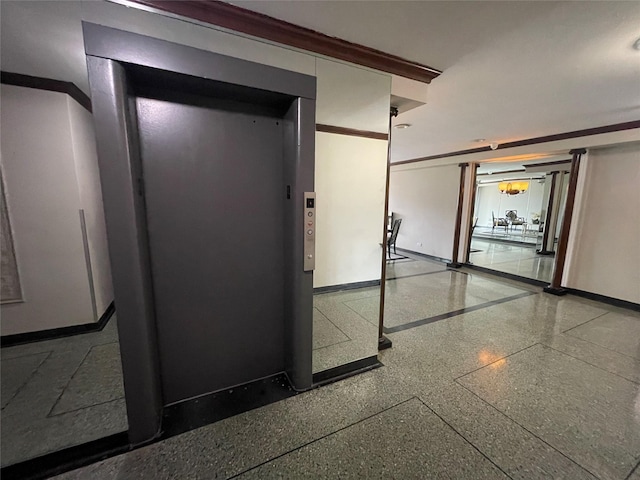 hallway with crown molding and elevator