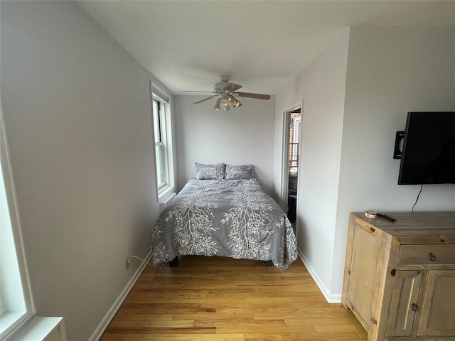 bedroom with ceiling fan and light wood-type flooring