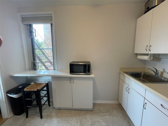 kitchen with sink and white cabinets