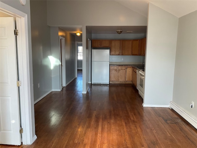 kitchen with vaulted ceiling, a baseboard radiator, dark hardwood / wood-style flooring, and white appliances