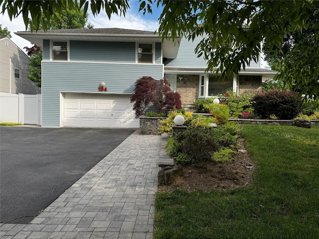 view of front of house featuring a garage and a front yard