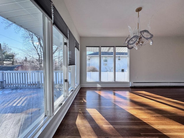 unfurnished sunroom with a baseboard radiator and a chandelier