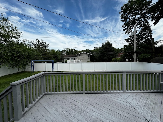 wooden terrace featuring a lawn