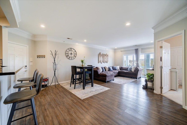 living room with baseboards, dark wood finished floors, visible vents, and crown molding