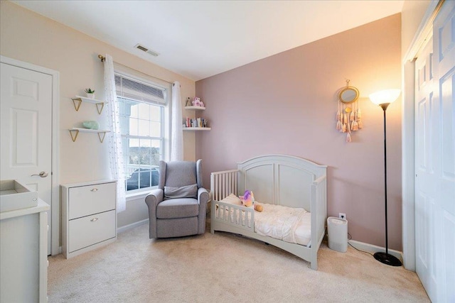 bedroom with light colored carpet, visible vents, and baseboards