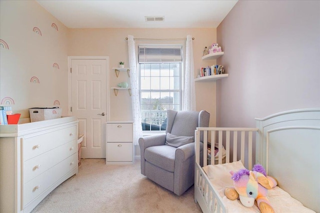 bedroom featuring light carpet and visible vents