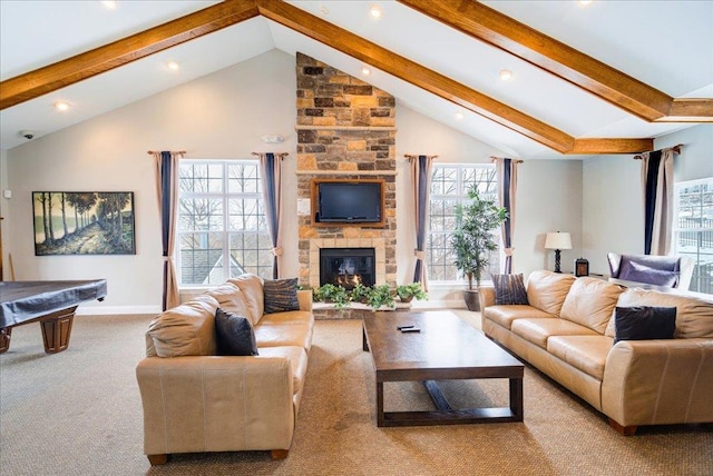 carpeted living room featuring baseboards, a fireplace, high vaulted ceiling, and beamed ceiling