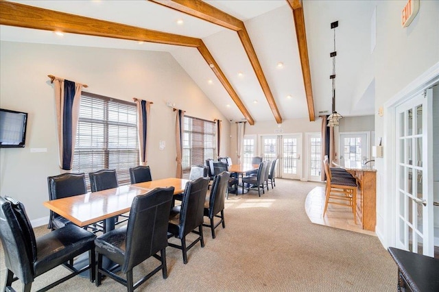 dining space featuring light carpet, baseboards, beamed ceiling, and french doors