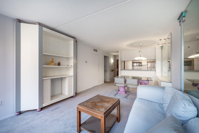 living room with light carpet and a textured ceiling