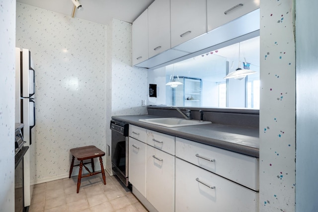 kitchen with black dishwasher, sink, white cabinets, and decorative light fixtures