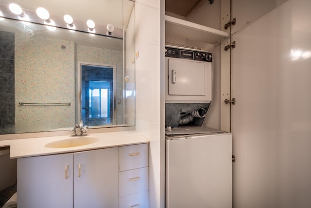 bathroom featuring vanity and stacked washer and clothes dryer