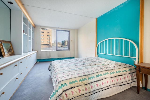 carpeted bedroom featuring a baseboard heating unit