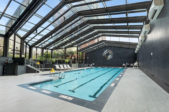 view of swimming pool with a wall mounted air conditioner, a lanai, and a patio