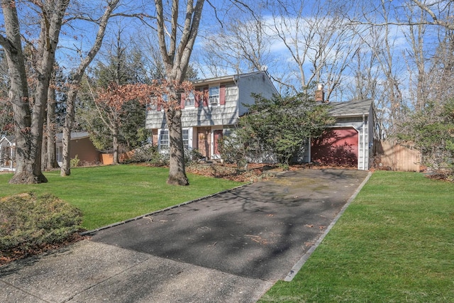 view of front facade with a garage and a front lawn