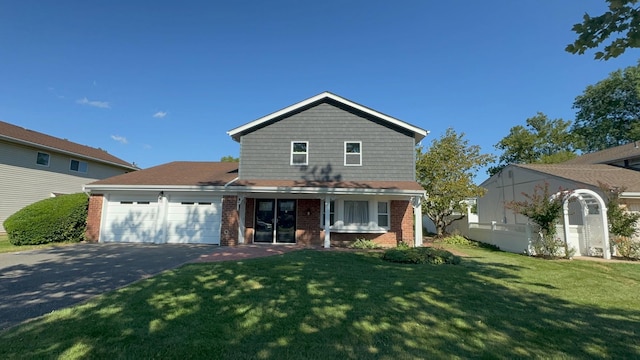 view of property featuring a garage and a front yard