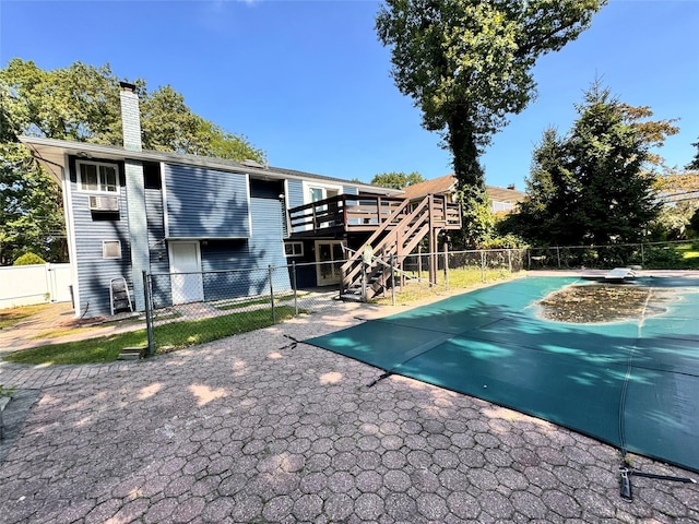 view of pool featuring a wooden deck and a patio area