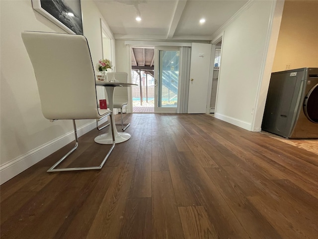 interior space with washer / dryer, wood-type flooring, and beamed ceiling