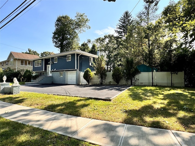 raised ranch featuring a front yard