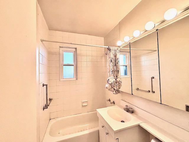 bathroom with vanity and shower / tub combo