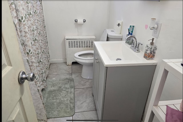199 Dartmouth St, Hempstead, NY 11550 - bathroom with vanity, radiator heating unit, tile patterned floors, and toilet