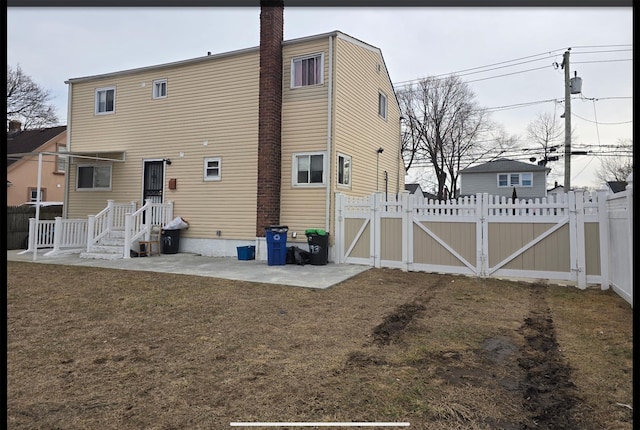 199 Dartmouth St, Hempstead, NY 11550 - rear view of house with a lawn and a patio