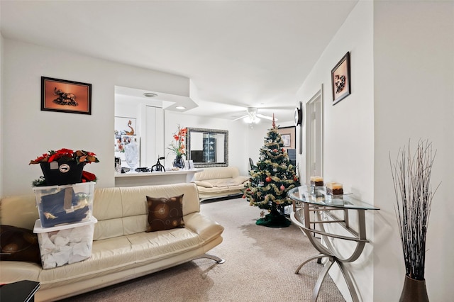 living room featuring carpet and ceiling fan