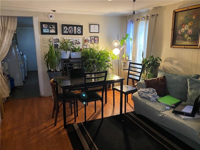 dining room featuring hardwood / wood-style flooring and crown molding