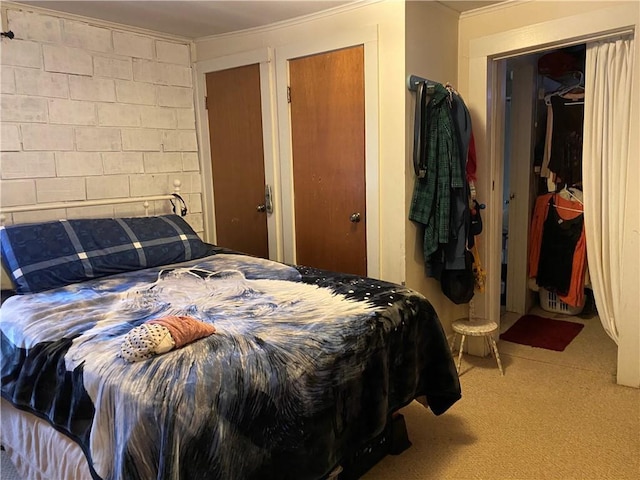 bedroom featuring crown molding and carpet