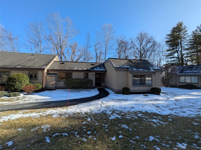 view of snow covered rear of property