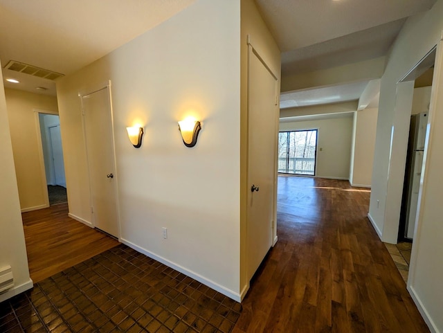 corridor featuring dark hardwood / wood-style flooring