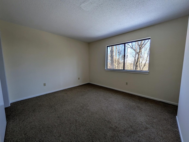 carpeted empty room with a textured ceiling